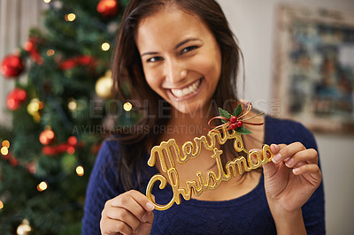 Buy stock photo Christmas, decoration and portrait of woman in home enjoying holiday, vacation and festival celebration. Happiness, festive party and girl holding merry Christmas sign in hand for Christmas tree