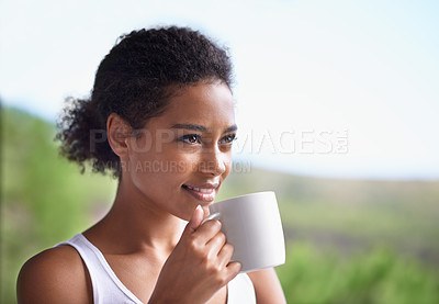 Buy stock photo Cropped shot of a young woman enjoying a cup of coffee