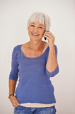 Buy stock photo Senior woman, phone call and portrait in studio with smile for conversation, chat and fashion by background. Mature person, smartphone and happy to listen to story, gossip or news on mobile network