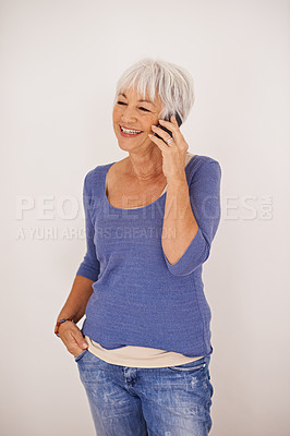 Buy stock photo Senior woman, phone call and happy in studio with memory in conversation, chat and fashion by background. Mature person, smartphone and smile with listening to story, gossip or news on mobile network