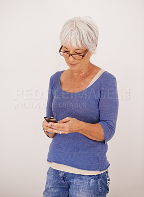 Buy stock photo Senior woman, smartphone and social media for contact, communication and talking with smile isolated on white background. Happy, female person and cellphone for connectivity, discussion or in studio