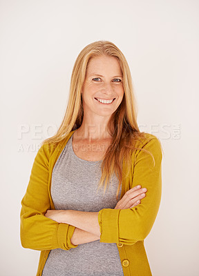 Buy stock photo Portrait of a confident woman standing with her arms crossed