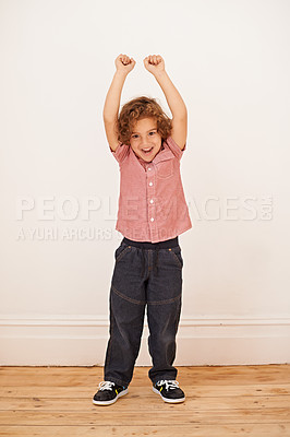 Buy stock photo Excited boy, child and portrait with fist in air by wall in family home for game, winning or success. Kid, happy and playful with smile for victory, cheers and celebration for fun in living room