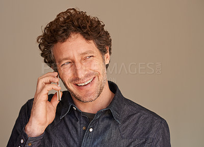 Buy stock photo Mature man, phone call and smile in studio for thinking, listening and chat for news with connection background. Person, smartphone and happy with ideas for conversation, contact or mobile networking