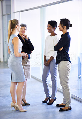 Buy stock photo Shot of a group of business colleagues having a conversation in the office