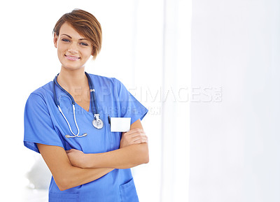 Buy stock photo Portrait of a confident young doctor wearing blue scrubs