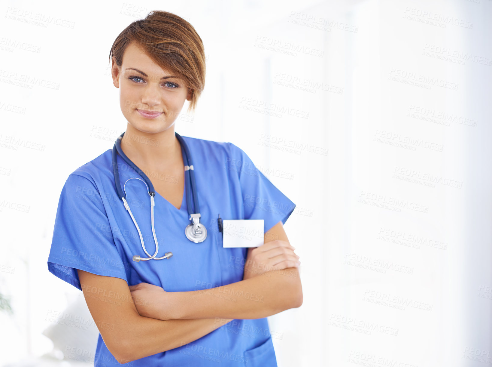 Buy stock photo Smile, arms crossed and portrait of nurse in hospital for support, healthcare and life insurance. Woman, scrubs and stethoscope with pride for confidence, wellness and medical service at clinic