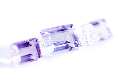 Buy stock photo Amethyst, rocks or gem in studio by white background for natural resource, jewelry and baguette style for luxury. Stone, purple crystal and closeup with shine, glow and brilliant cut for collection