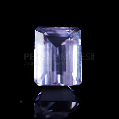 Buy stock photo Purple, gemstone or jewelry on a black background for luxury, expensive and rich design in studio. Violet, diamond or crystal rock for texture, glamour and ring with shine and reflection for gift