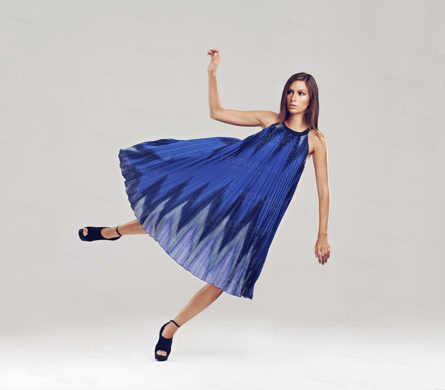 Buy stock photo Full length shot of a gorgeous brunette floating in a blue dress