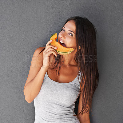 Buy stock photo Slice of melon, portrait and woman with smile, nutrition and person on a grey background. Face, model and girl eating a fruit, wellness and mockup space with diet plan and healthy snack with treat