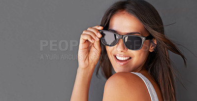 Buy stock photo Shot of an attractive young woman wearing sunglasses