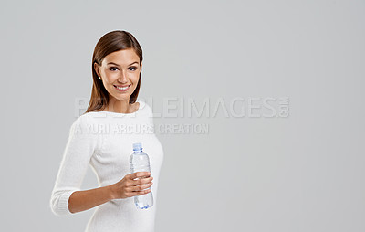 Buy stock photo Portrait, happy woman and drinking water in studio isolated on a white background mockup space for wellness. Face, bottle and person with liquid for hydration, nutrition and healthy diet for body