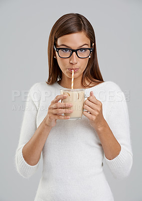 Buy stock photo Studio, woman and glasses with coffee, drink and ice for relax and rest. Model, beverage and straw with glass mug, portrait and face for break or nutrition with milkshake isolated on white background