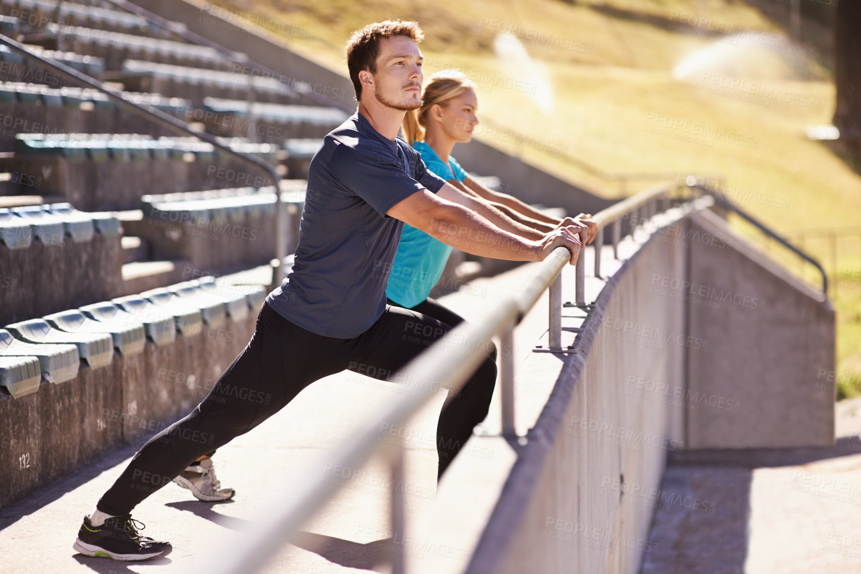 Buy stock photo Sports, legs and couple stretching in stadium for race, marathon or competition training for health. Fitness, wellness and runner athletes with warm up exercise for running cardio workout on track.