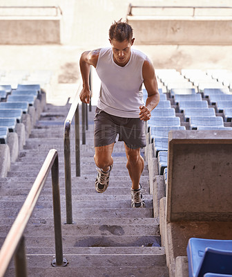 Buy stock photo Shot of an athlete running up a flight of stairs as part of his training