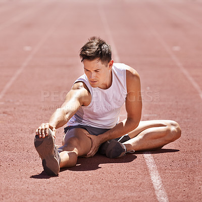 Buy stock photo Athlete, stretching and man outdoor for exercise, running or workout at sports stadium. Male runner or sport person on ground training legs and body for fitness, competition and wellness on track