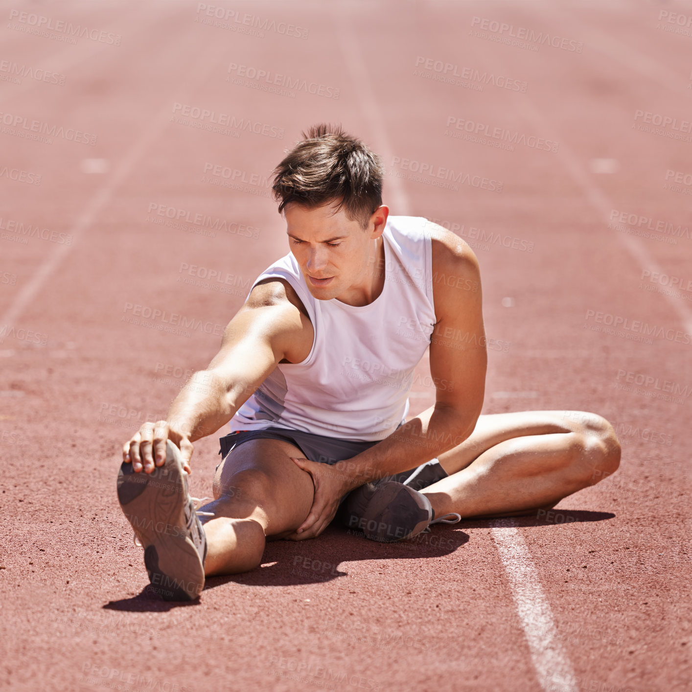 Buy stock photo Athlete, stretching and man outdoor for exercise, running or workout at sports stadium. Male runner or sport person on ground training legs and body for fitness, competition and wellness on track