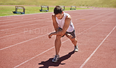 Buy stock photo Fitness, running and stretching with athlete man getting ready on track for sports, race or competition. Exercise, training and warm up with confident young person at stadium or venue for event
