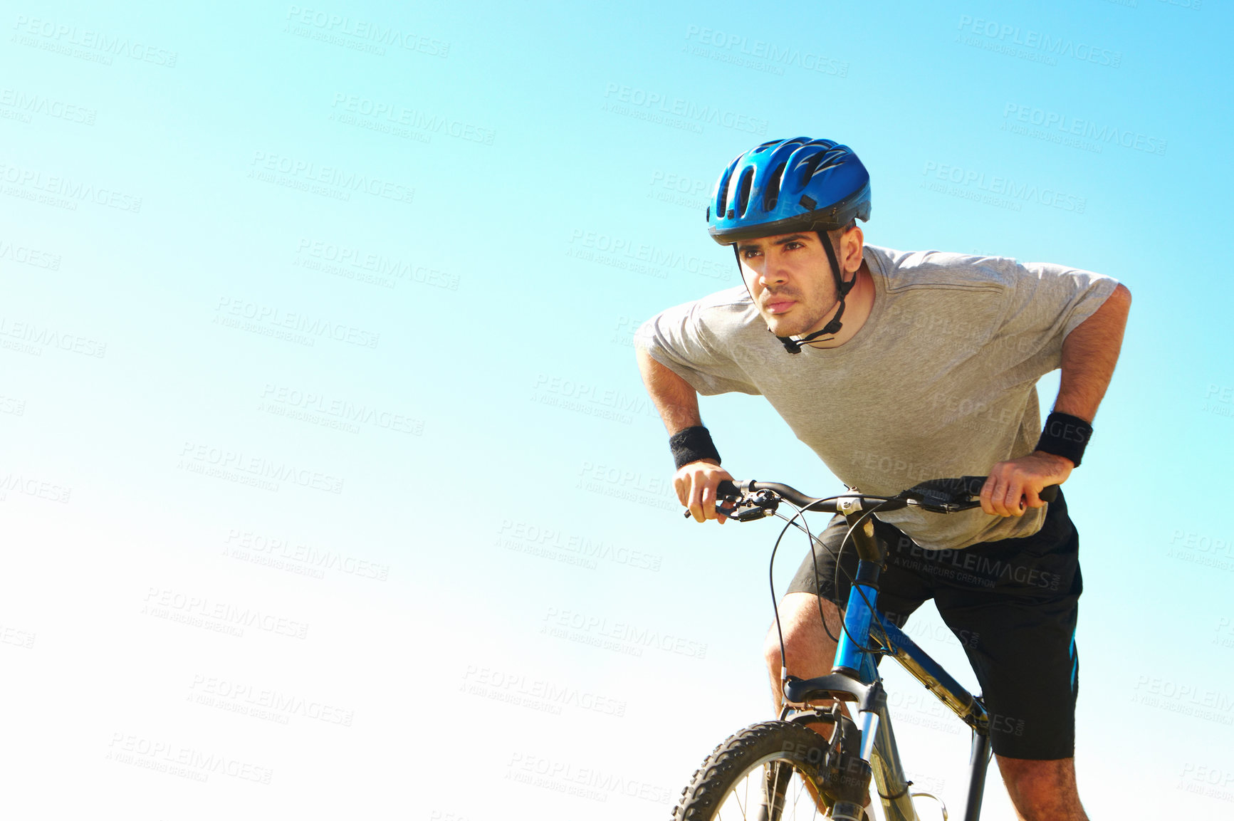 Buy stock photo Cropped shot of a handsome young cyclist outdoors