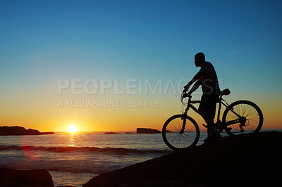 Buy stock photo Man, beach and silhouette with mountain bike, sunset and mockup space by waves for summer cycling adventure. Cyclist, freedom and fitness with bicycle, training or journey by ocean in dusk sunshine