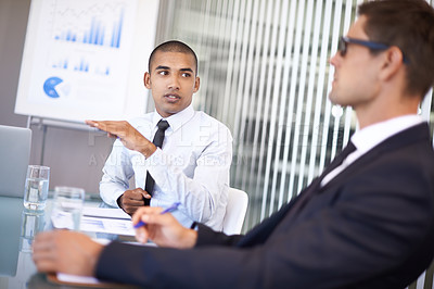 Buy stock photo Shot of a businessman explaining a concept to his colleague during a meeting
