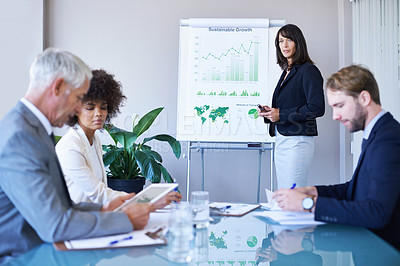 Buy stock photo Businesswoman, presentation and conference room with charts for analytics report or growth, development or graphs. Female person, colleagues and company strategy or finance sales, meeting or teamwork