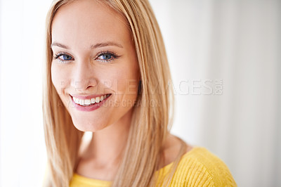 Buy stock photo A young woman standing in her home smiling happily