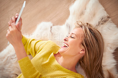 Buy stock photo Tablet, smile and meme with woman on floor of home for browsing or communication from above. Technology, social media and funny with young person laughing in living room of apartment on weekend