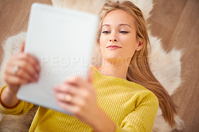 Buy stock photo Tablet, face and social media with woman on floor of home for browsing, communication or weekend free time. Technology, app and relax with young person in living room of apartment from above