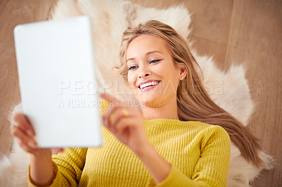 Buy stock photo Tablet, happy and social media with woman on floor of home for weekend browsing or communication from above. Technology, smile and relax with young person in living room of apartment for download