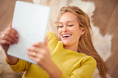 Buy stock photo Face, tablet and smile with woman on floor of home for weekend browsing or communication from above. Technology, relax and happy with young person laughing in living room of apartment for download