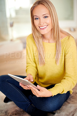 Buy stock photo A beautiful young woman sitting comfortably on the floor at home