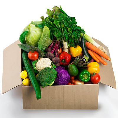 Buy stock photo Studio shot of a cardboard box filled with fruit and vegetables