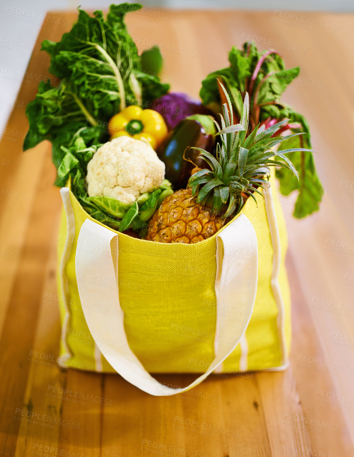 Buy stock photo Shot of an assortment of fruit and vegetables in a shopping bag