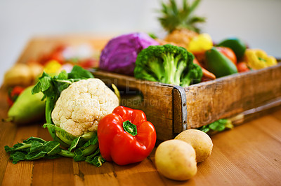 Buy stock photo Shot of a collection of fruit and vegetables lying on a table