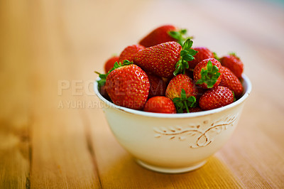 Buy stock photo Food, health and strawberry bowl in kitchen of home, on wooden counter top for diet or nutrition. Fruit, wellness and lose weight with berries on surface in apartment for detox, minerals or vitamins