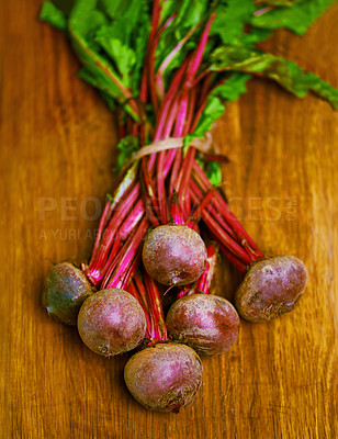 Buy stock photo Beetroot, closeup and counter for health, wellness or organic diet on wood countertop. Vegetable, nutrition or produce for eating, gourmet and meal or cuisine with minerals or fibre for weight loss