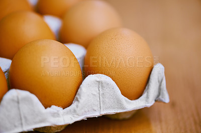 Buy stock photo Agriculture, protein and eggs in carton for sustainable, organic food and reproduction with wellness. Diet, closeup and produce from livestock for nutrition, breakfast or healthy meal on table