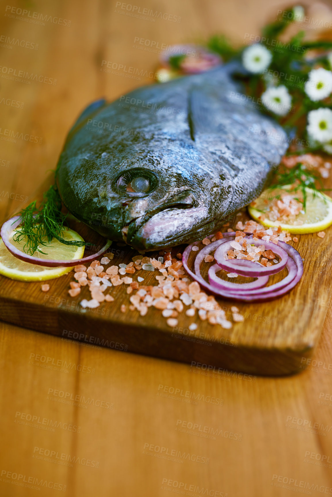 Buy stock photo Fresh, fish and food on table for nutrition with seasoning, protein and health ingredient for cooking and baking. Wooden board, produce and healthy meal with vitamins, onions and lemon for gourmet