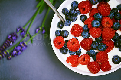 Buy stock photo High angle, berries and bowl with yogurt, raspberry and blueberry for organic snack. Food, cuisine and lavender for health, wellness and diet for morning nutrition and antioxidant wellbeing in studio