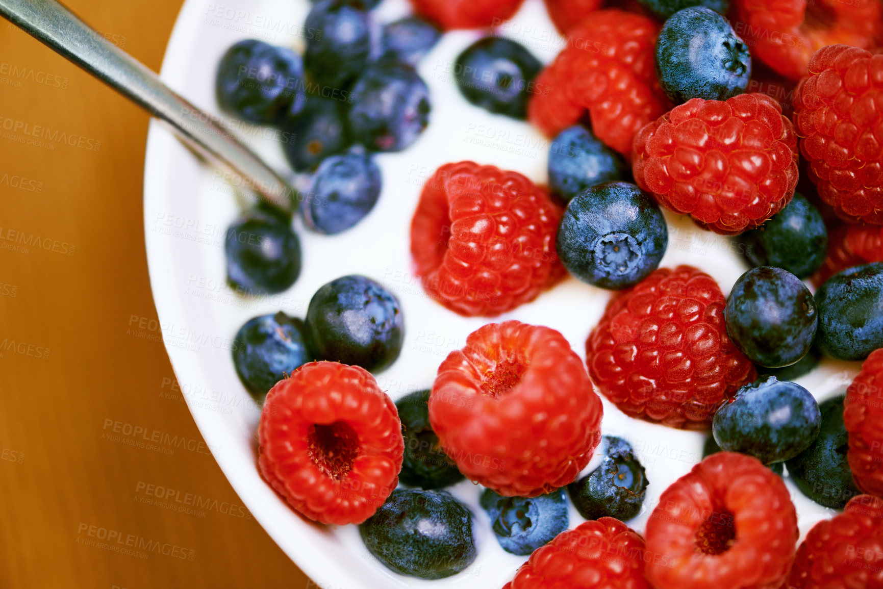 Buy stock photo Raspberry, berries and bowl with yogurt, closeup and blueberry for organic snack. Food, cuisine and breakfast for health, wellness and diet for morning nutrition and antioxidant wellbeing in studio