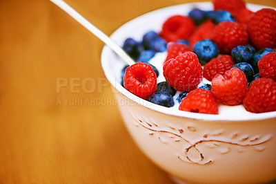 Buy stock photo Closeup, berries and bowl with yogurt, raspberry and blueberry for organic snack. Food, cuisine and breakfast for health, wellness and diet for morning nutrition and antioxidant wellbeing in studio