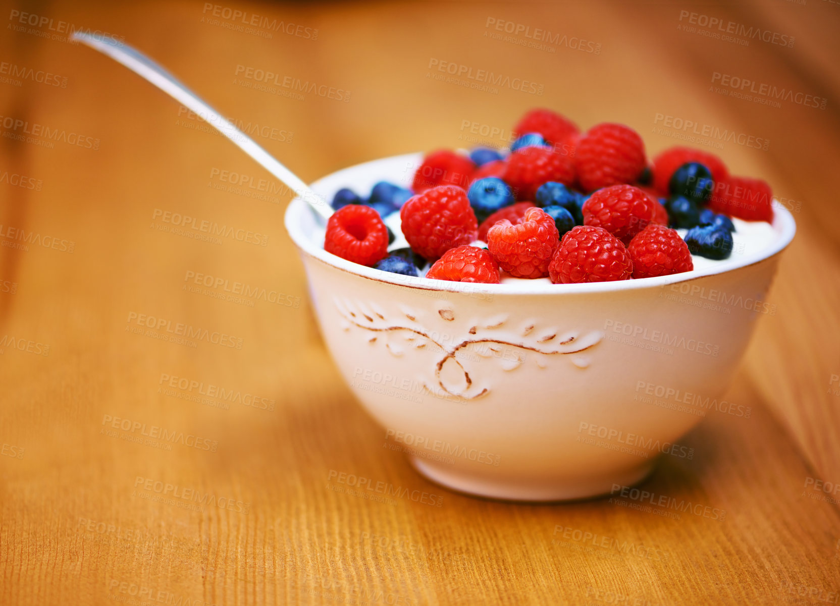 Buy stock photo Wood, berries and bowl with yogurt, raspberry and blueberry for organic snack. Food, cuisine and breakfast for health, wellness and diet for morning nutrition and antioxidant wellbeing in studio