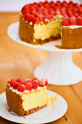 Buy stock photo Slice, dessert and cheesecake for bakery, raspberries and sweet snack for eating. Fruit, plate and cake stand for display on table in pastry restaurant, creamy or luxury baked confection with berries