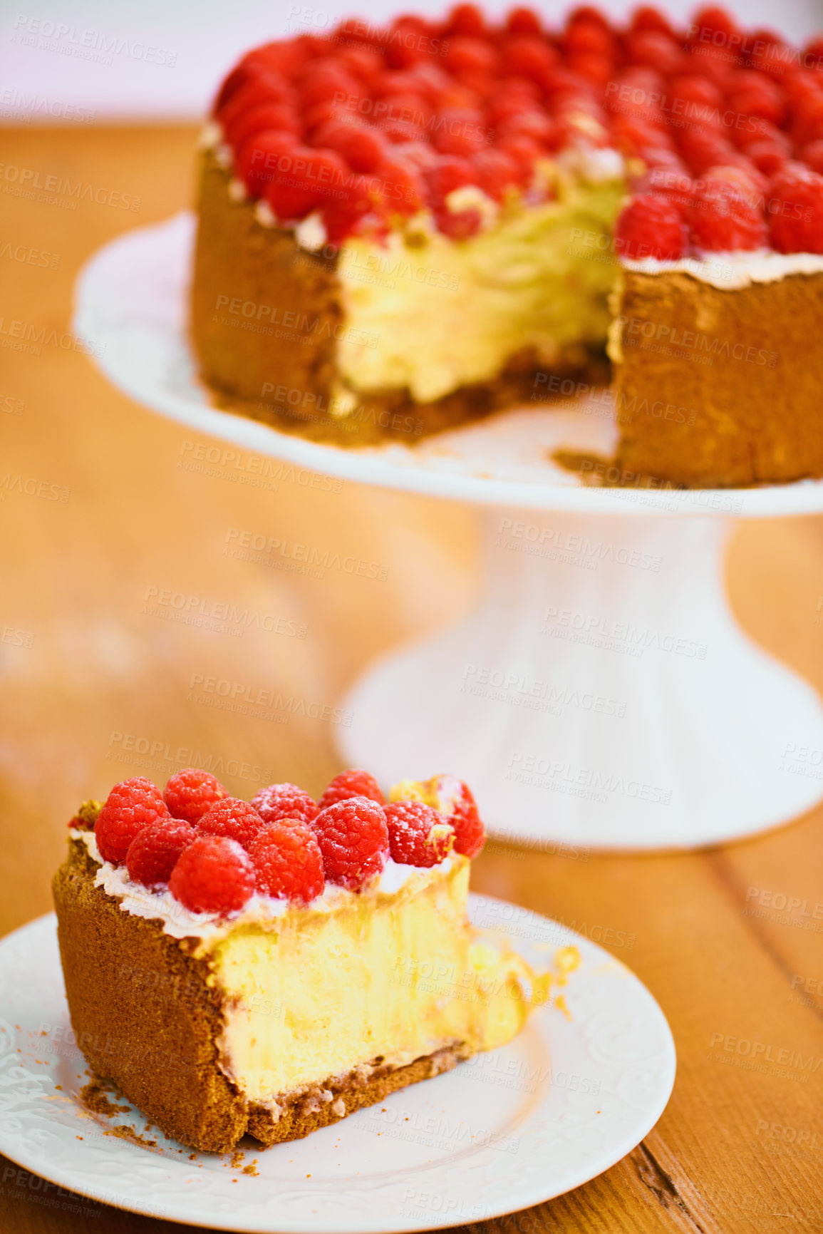 Buy stock photo Slice, dessert and cheesecake for bakery, raspberries and sweet snack for eating. Fruit, plate and cake stand for display on table in pastry restaurant, creamy or luxury baked confection with berries