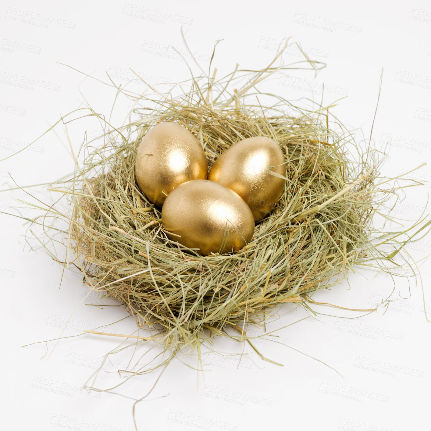 Buy stock photo Studio shot of a clutch of golden eggs laying in a nest