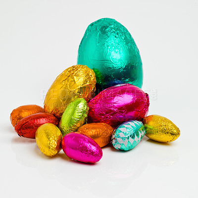 Buy stock photo Studio shot of a dazzling array of multicolored easter eggs wrapped in foil