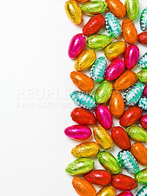 Buy stock photo Easter, egg and chocolate sweets for holiday celebration or dessert candy on white background, present or snack. Food, eating and pattern with mockup space for festive season, tradition or tinfoil