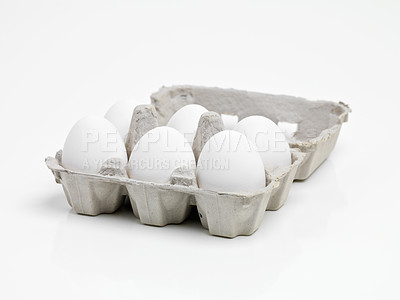 Buy stock photo Studio shot of half a dozen white eggs in a carton